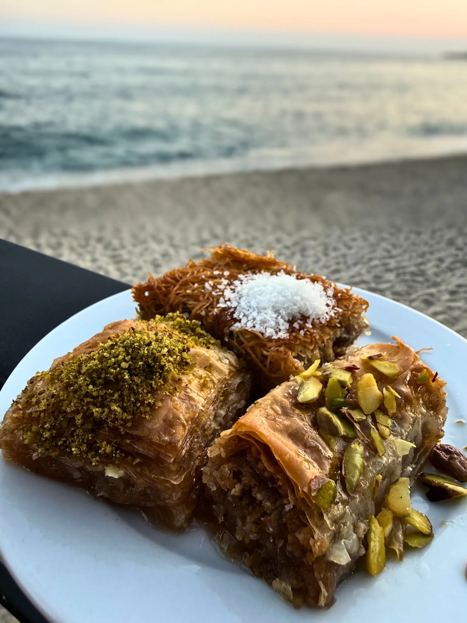 Food photograph — pastries on a plate at the beach